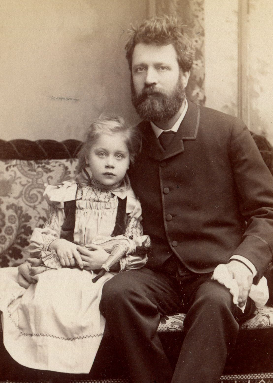 Antique photo bearded man and girl holding china doll
